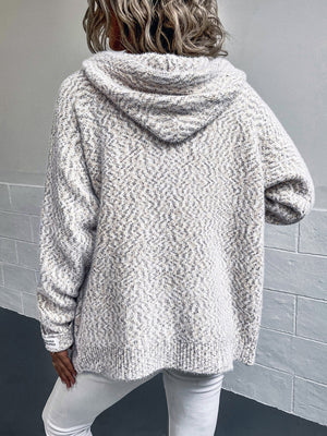 Textured knit hooded cardigan in a speckled white and grey pattern with a subtle herringbone texture.
