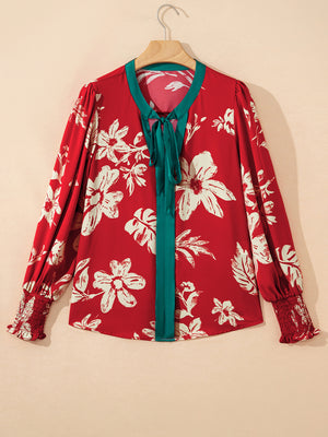 Red floral print blouse with bow tie detail and smocked cuffs