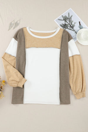 Colorblock slouchy knit top in tan with seam details and long sleeves.