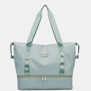 Pale blush dual-compartment travel tote with metallic trim and dual zippers.