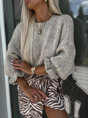 Voluminous sleeve knit sweater in heather grey acrylic with ruffled cuffs.