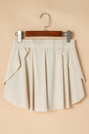 Beige ruffled skort with elastic waist and tie detail