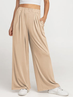 Pleated palazzo trousers in taupe with pockets and elastic waistband.