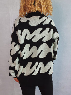 Graphic wave knit sweater in black and white with a crew neck and long sleeves.