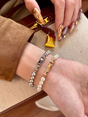 Elegant pearl bracelets with zircon accents in silver and gold tones.