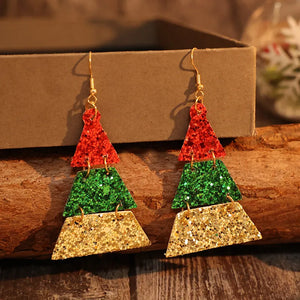 Festive glitter tiered Christmas tree earrings in red, green, and gold.