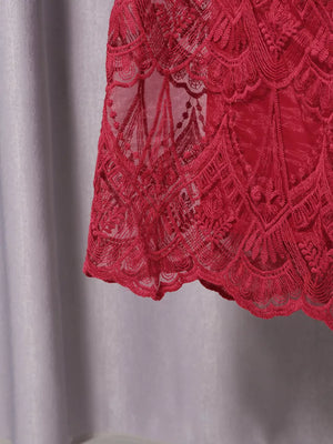 Red lace midi dress with ornate pattern and scalloped hem detail.