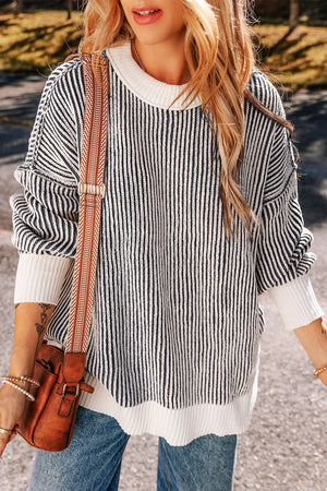 Black and white striped drop-shoulder knit sweater with a crew neck and ribbed hem.