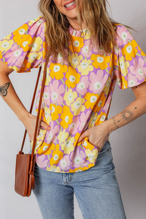 Puff sleeve blouse with ruffle trim and a colorful floral print.
