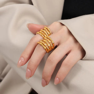Gold sculptural titanium bamboo ring with layered design on hand