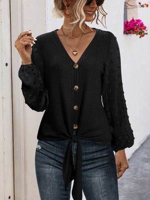 Black waffle knit tie front blouse with swiss dot sleeves and button front.