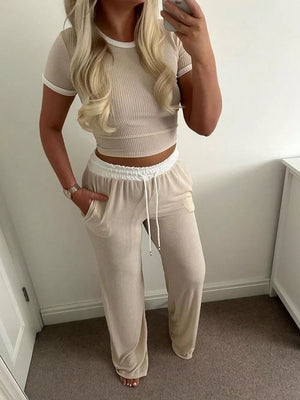Ribbed two-piece set with contrast trim, featuring a crop top and wide-leg pants.