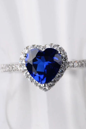 Blue heart halo engagement ring with clear accent stones on band