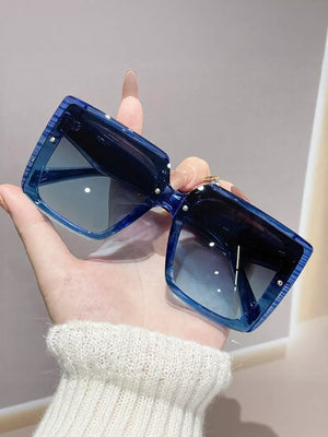 Oversized square blue gradient sunglasses with chunky acetate frames.