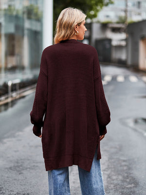 Open-stitch waffle knit duster cardigan in deep red with side slits and balloon sleeves.