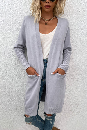 Light grey ribbed cuff open-front cardigan with pockets, styled with jeans.