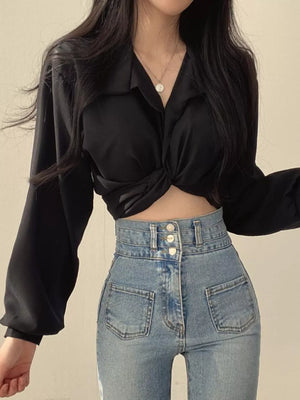 Black long sleeve shirt with twisted knot front detail and buttoned collar.
