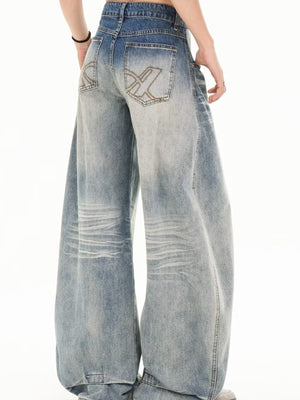 Men's light wash wide leg jeans with distressed details and embroidered back pockets.