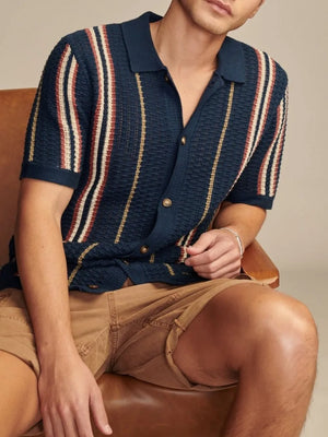 Navy textured knit polo shirt with vertical stripes and short sleeves.