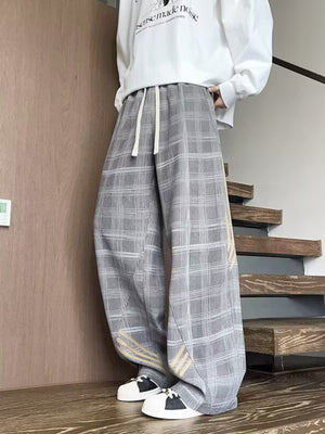 Men's gray plaid wide leg sweatpants with drawstring waist and subtle stripe detail.