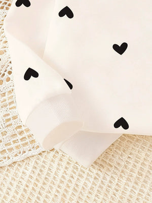 Baby top with black heart print and ribbed cuff detail