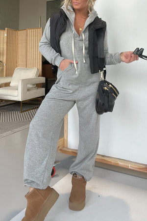 Gray hooded lounge jumpsuit with wide leg pants and drawstring hood.