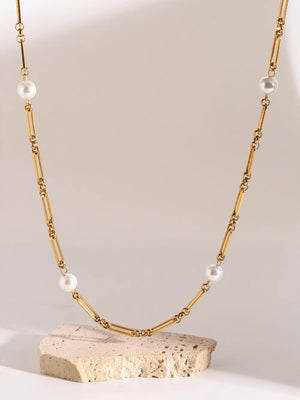 Gold two-tone pearl link necklace with rectangular chain links and white pearls.