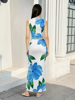 Floral crop top and maxi skirt set with blue floral print and green leaves.