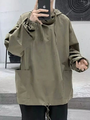 Oversized green drawstring hoodie with elastic cuffs, large front pockets, and adjustable hem.