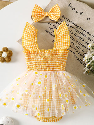 Yellow gingham baby one-piece with smocked bodice, ruffled straps, daisy-print tulle skirt and matching bow headband.