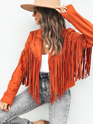 Orange fringe open front cropped jacket with lapels and long sleeves, styled with jeans.