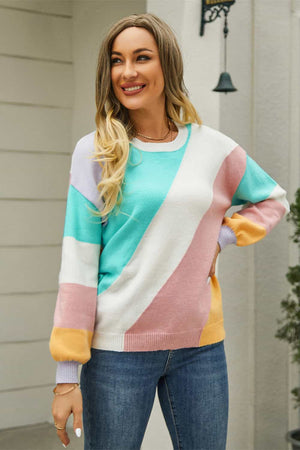 Geometric colorblock knit crewneck sweater with pastel diagonal stripes and ribbed cuffs.