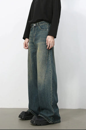 Dark wash wide-leg denim jeans with a relaxed fit and distressed details.