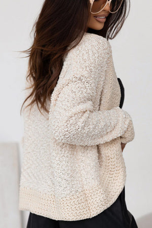 Cream bouclé open-front jacket with textured knit and relaxed fit.