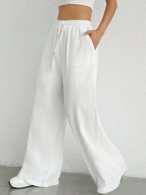 White linen wide-leg drawstring trousers with pockets