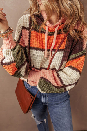 Waffle knit patchwork hoodie with colorblock pattern in orange, pink, green, and brown.