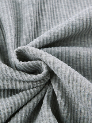 Grey ribbed knit fabric detail of a cozy hoodie and short set.