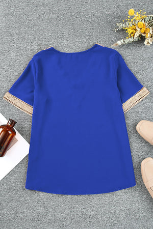Royal blue blouse with lace trim on V-neckline and short sleeves.