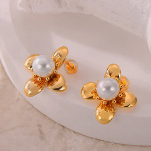 Gold petal pearl stud earrings with a flower design and small beaded accents.