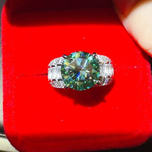 Silver band ring with emerald cut moissanite and baguette side stones.