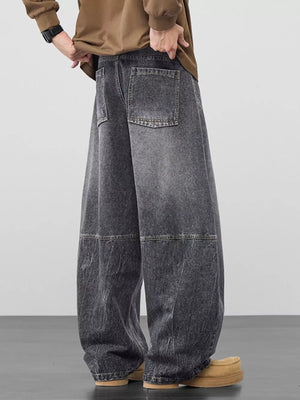 Refined wide-leg jeans in black gray denim with geometric panel detailing and back pockets.
