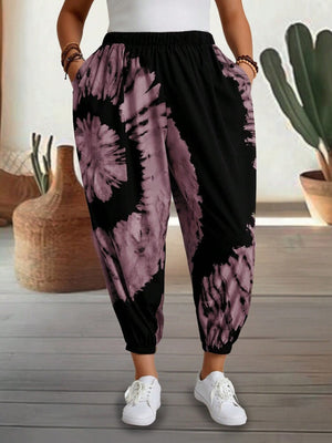 Tie-dye harem trousers in dusty pink and black with elastic waist and cuffed ankles.