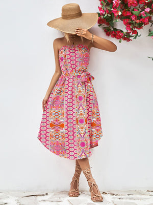 Printed bandeau midi dress with asymmetric hem and belt in hot pink.