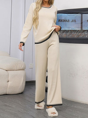 Cream acrylic knit sweater set with contrast trim and wide leg pants.