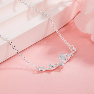 Silver necklace with delicate ginkgo leaf design and fine chain.