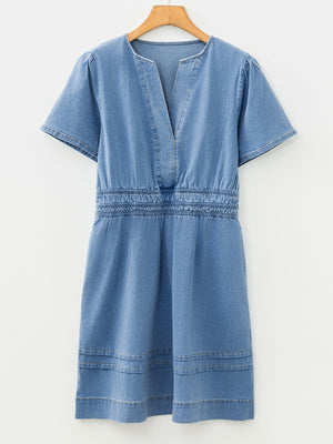 Chic denim dress with V-neck, short sleeves, elastic waist, and tiered hem.