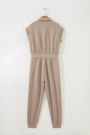 Chic collared zip front romper in tan with cap sleeves and ankle cuffs.