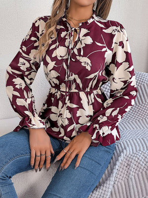 Burgundy floral peplum blouse with ruffled neck and tie detail