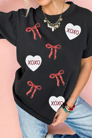Black cotton t-shirt with sequin heart and bow pattern, short sleeves, crew neck.