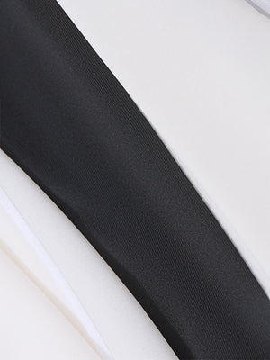 Black and white fabric detail of a dress with a bowknot accent